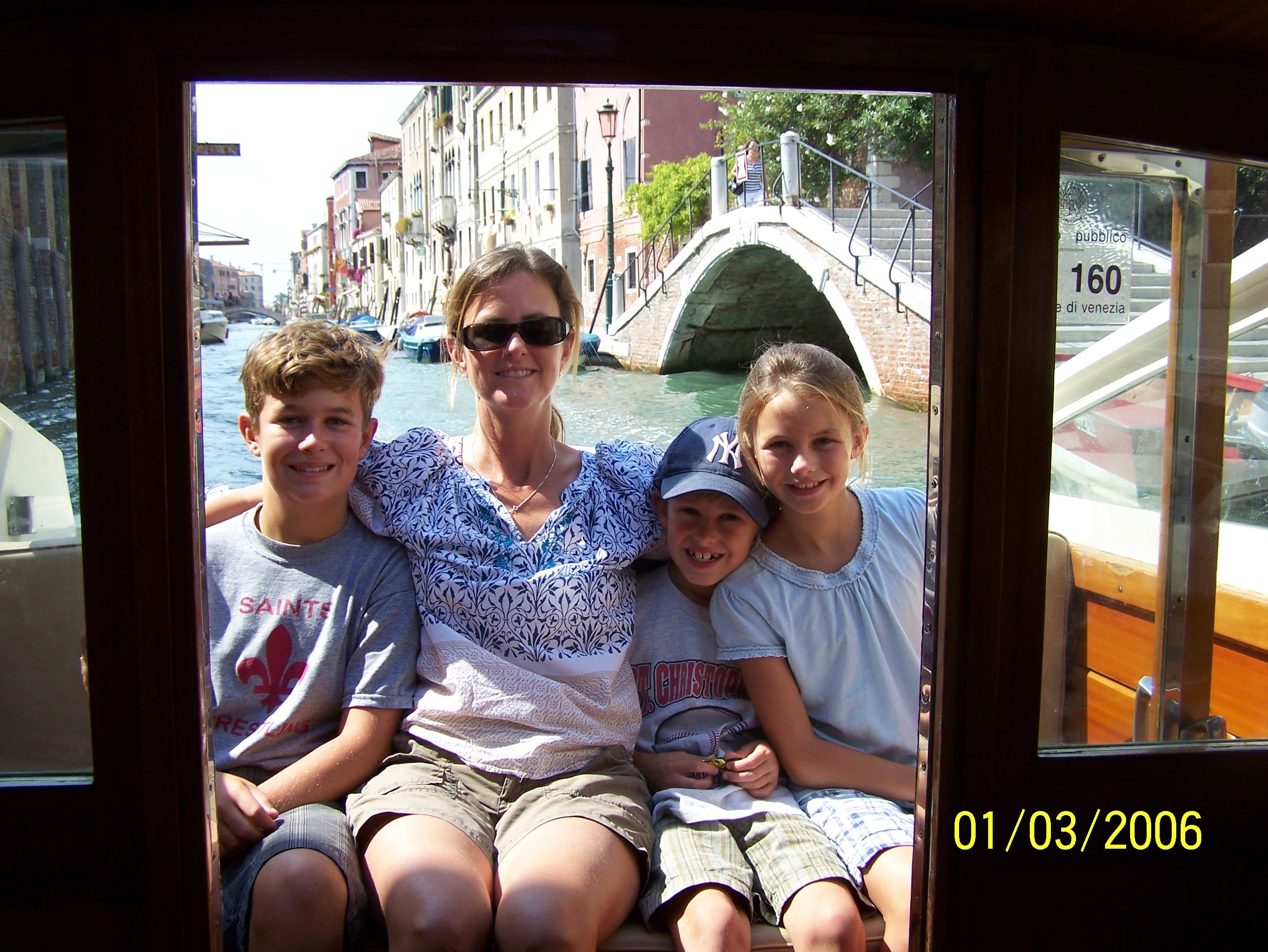 Family on a water taxi through the canals of Venice